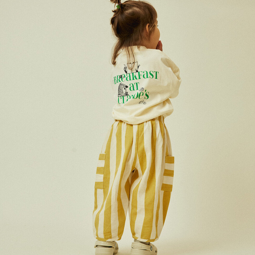 Toddler in pants that are a sun-bleached tonal golden stripe with contrast pocket direction.