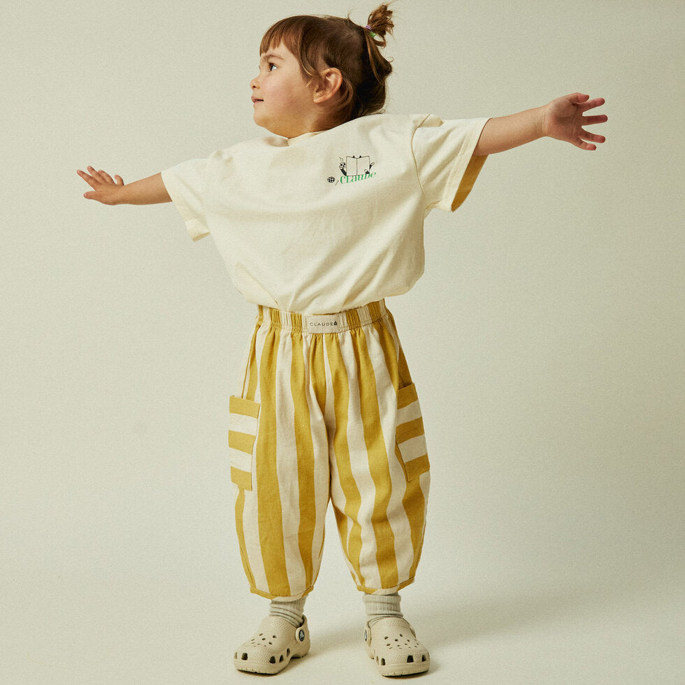 Toddler in pants that are a sun-bleached tonal golden stripe with contrast pocket direction.