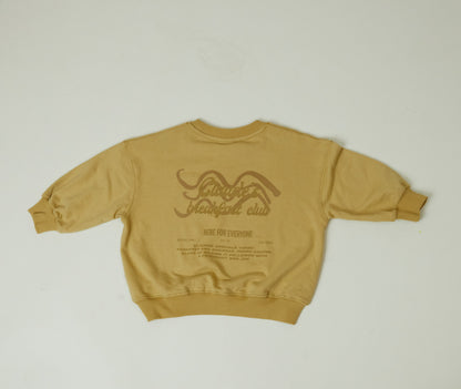 Jesse Sweater in a tonal mustard yellow featuring a banana image on front chest and a fun Claude & Co. breakfast slogan on the back.