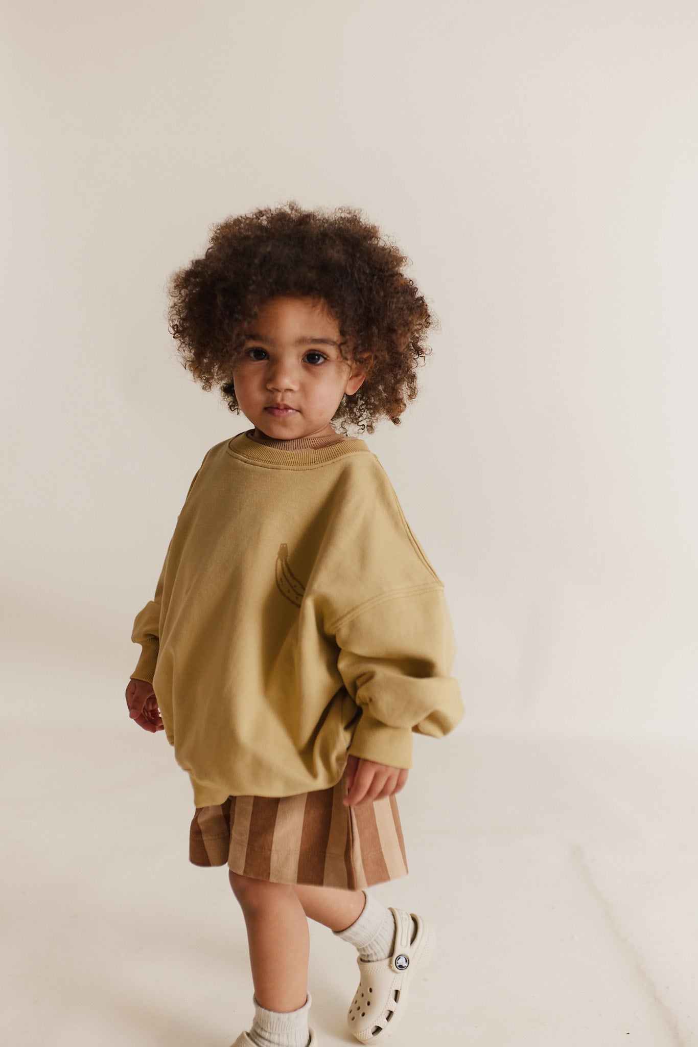 Jesse Sweater in a tonal mustard yellow featuring a banana image on front chest and a fun Claude & Co. breakfast slogan on the back.