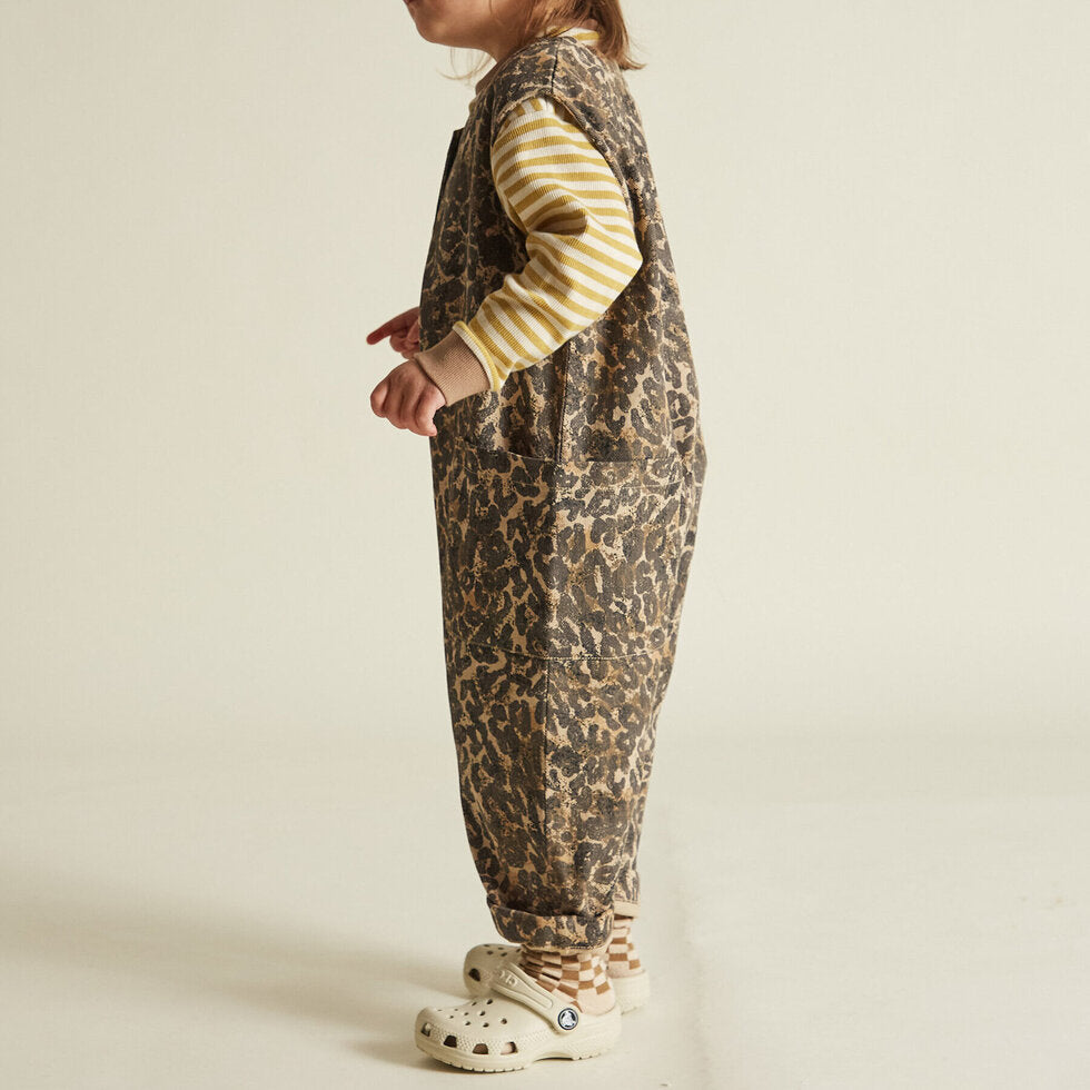 The Wren sleeveless and oversized Leopard print overall made with 100% soft organic cotton featuring tortoiseshell style buttons down to the crotch and playfully large, oversized pockets.